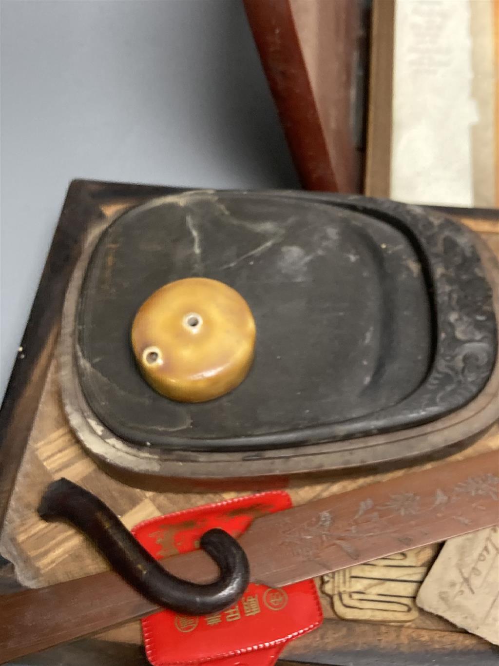 A group of Chinese and Japanese objects, 19th/20th century, including an inscribed ink box an inkstone, a lacquer bookslide, two Tibeta